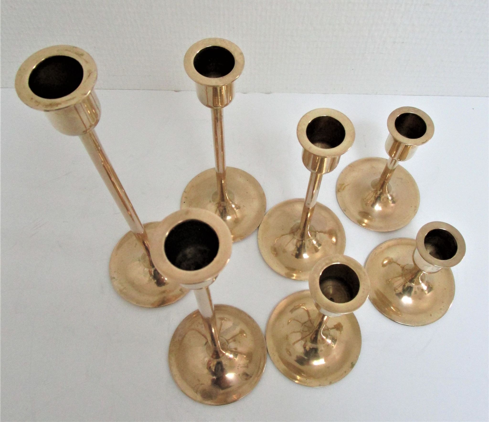 Series of seven candle holders solid brass