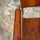 Vintage aluminum tube and tan leather armchair
