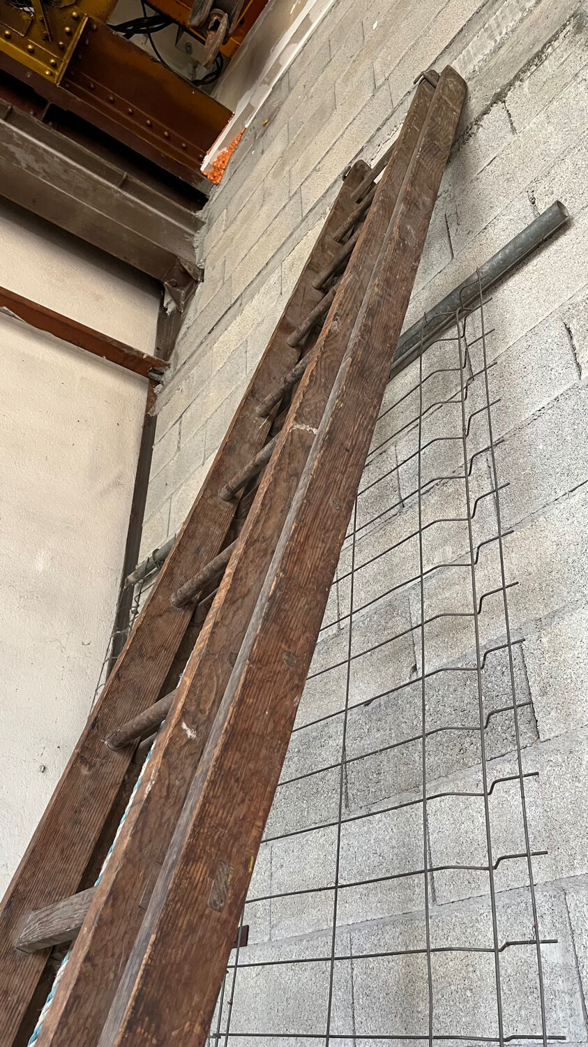 Very large vintage sliding wooden ladder