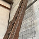 Very large vintage sliding wooden ladder
