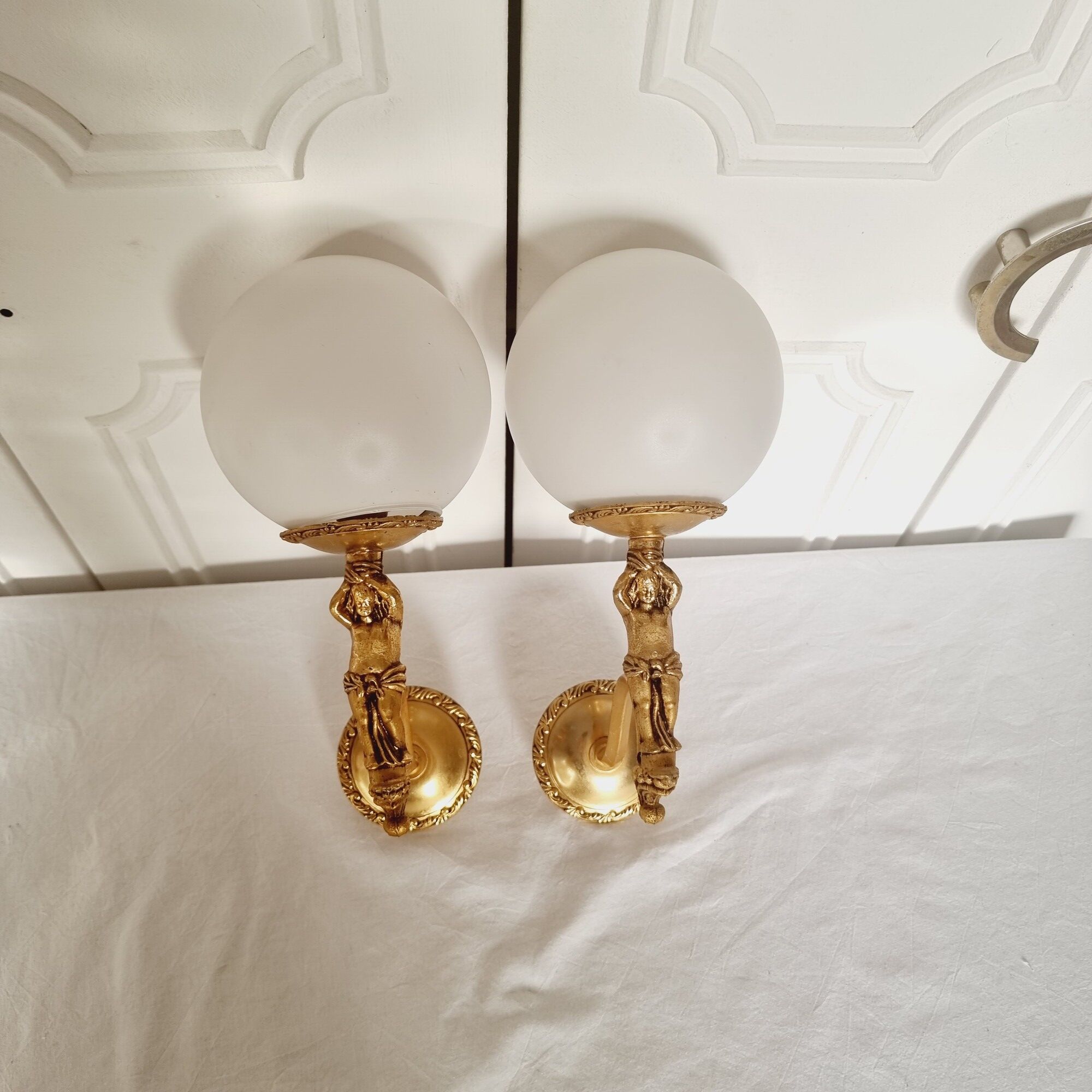 2 classic golden cherub wall lights and globe lampshades in perfect condition.
