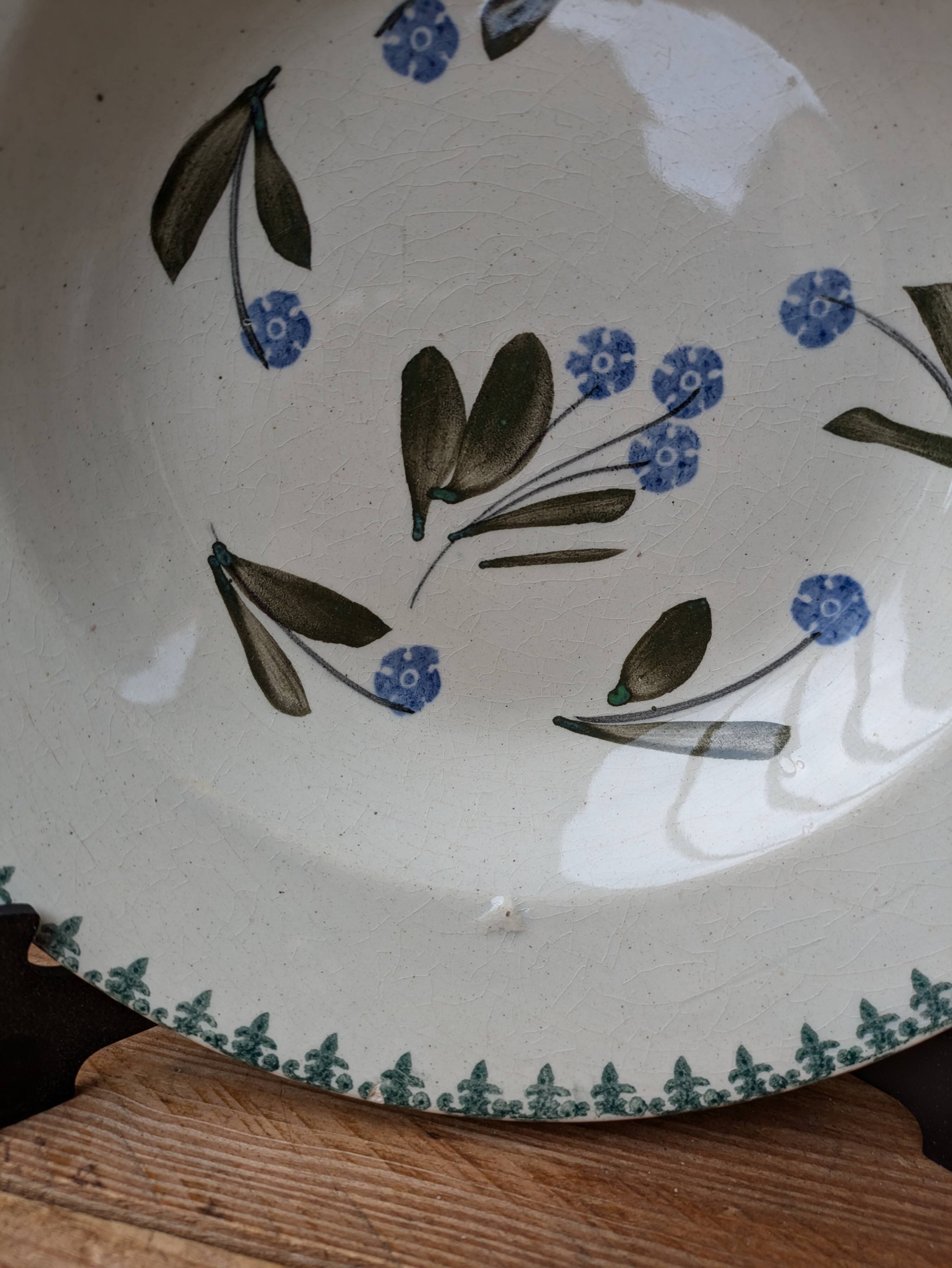 Old deep iron earth plate with blue flower pattern