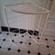 Cream and brass corner bakery shelf in wrought iron