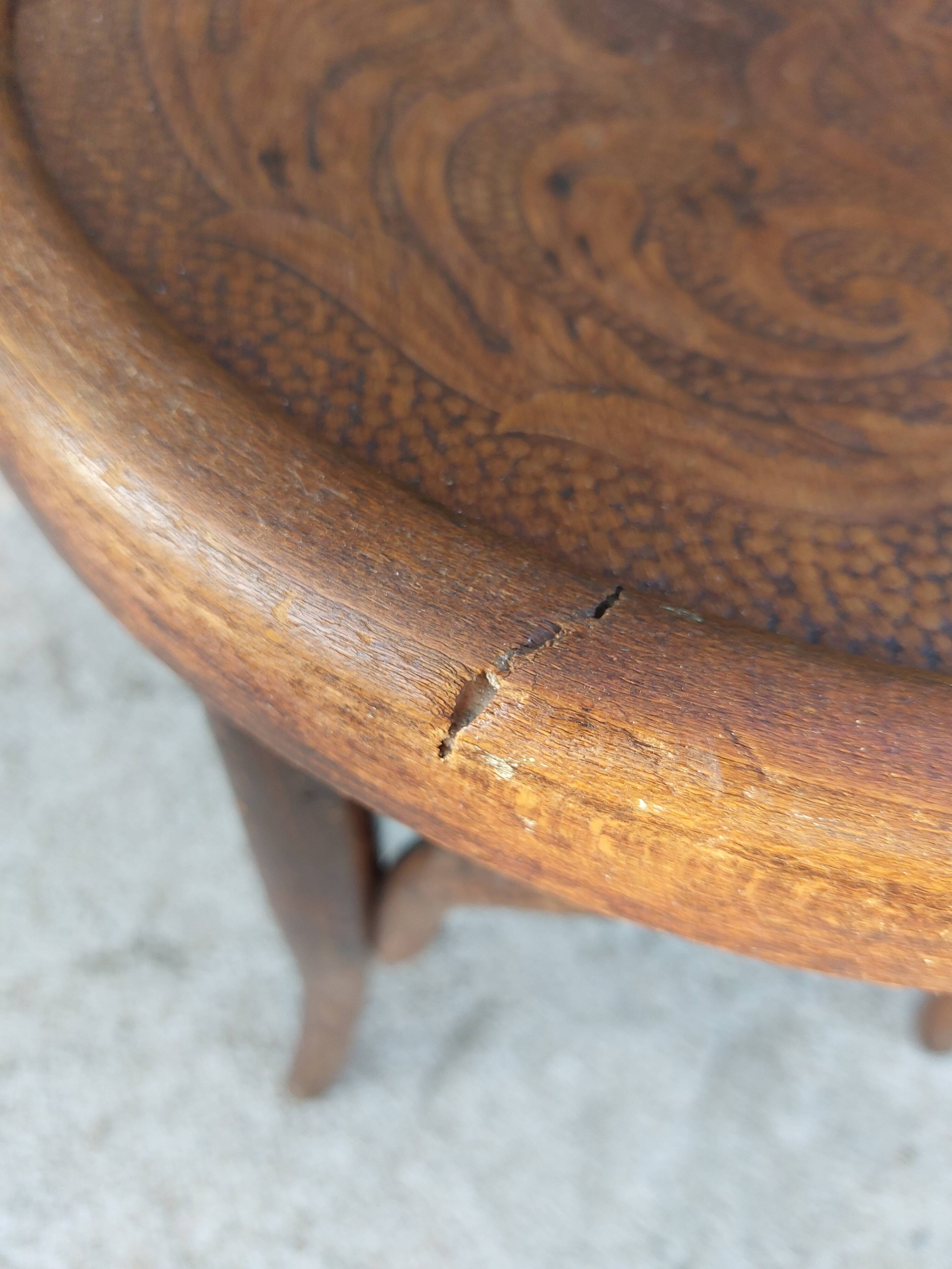 pair of round wooden chairs with a pattern on the seat