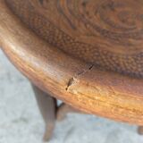 pair of round wooden chairs with a pattern on the seat