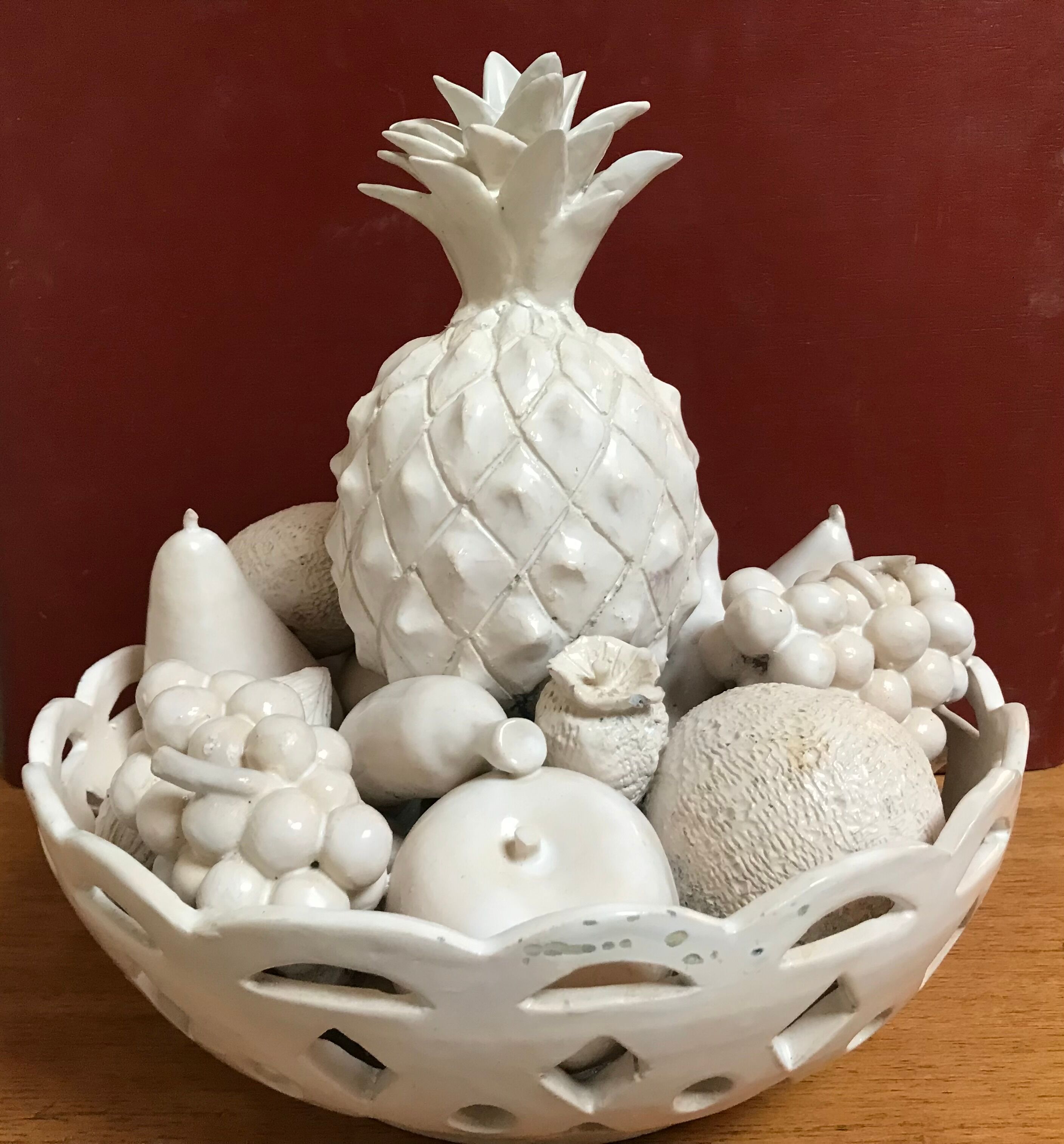 Trompe l'oeil fruit cut in white earthenware by Jean Roger, circa 1960.