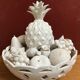 Trompe l'oeil fruit cut in white earthenware by Jean Roger, circa 1960.