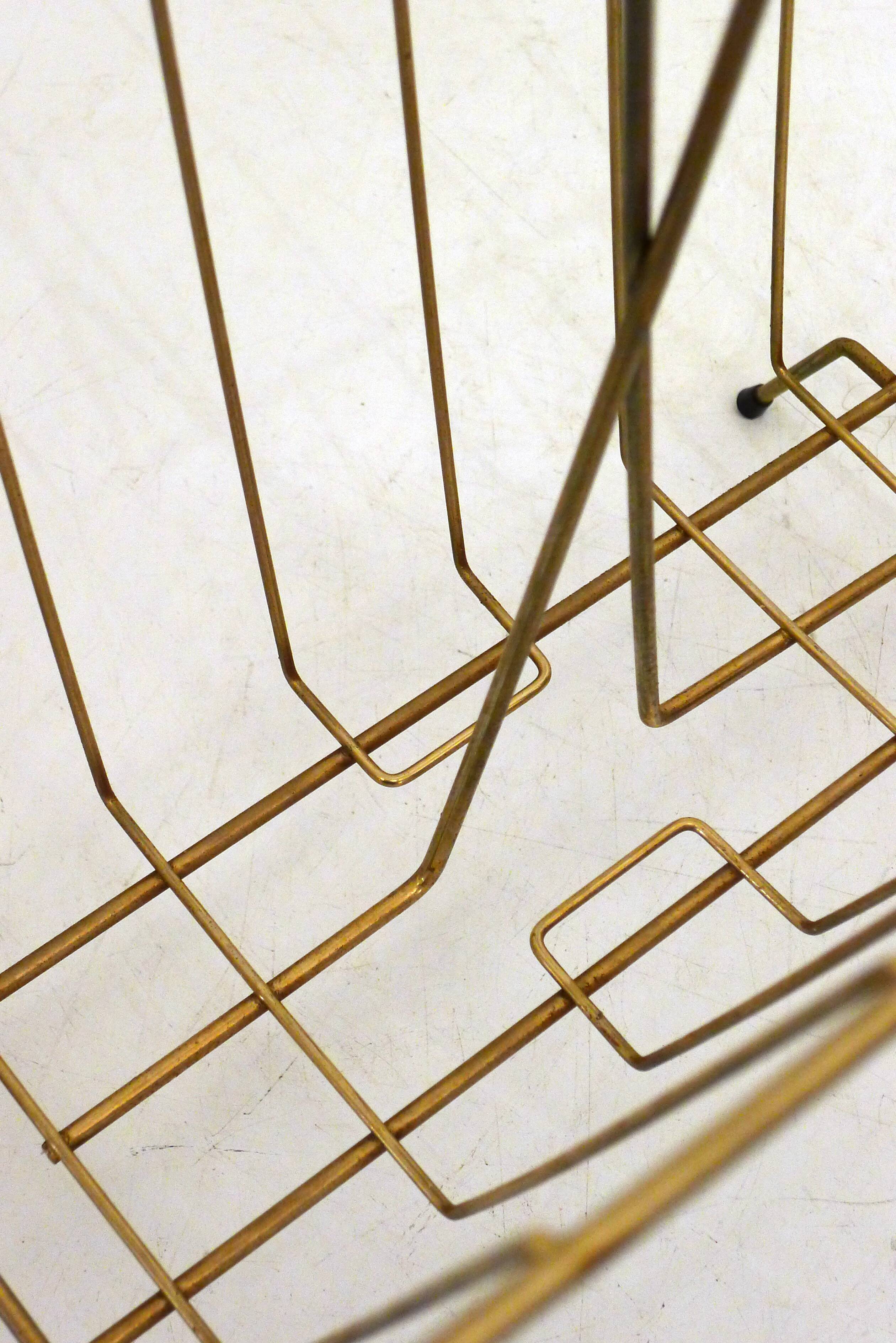 Mid-century openwork magazine rack, in gold metal & wooden handle.