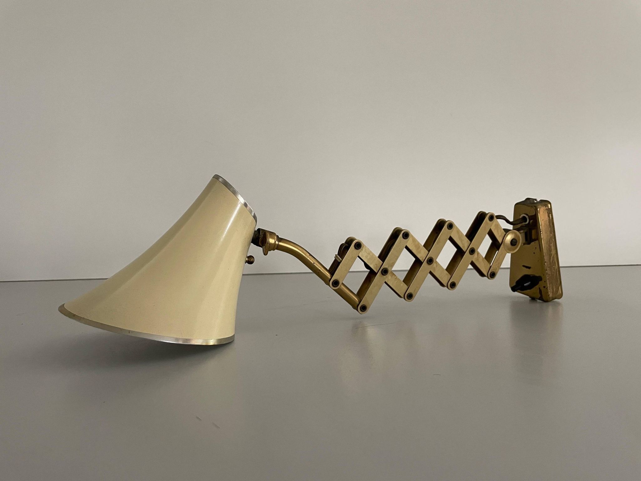 Cream metal and brass wall lamp with scissors design by Karl Lang for SIS Licht, 1950s, Germany.