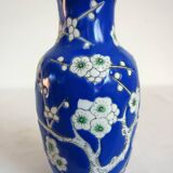 Old blue vase with vintage porcelain cherry blossoms