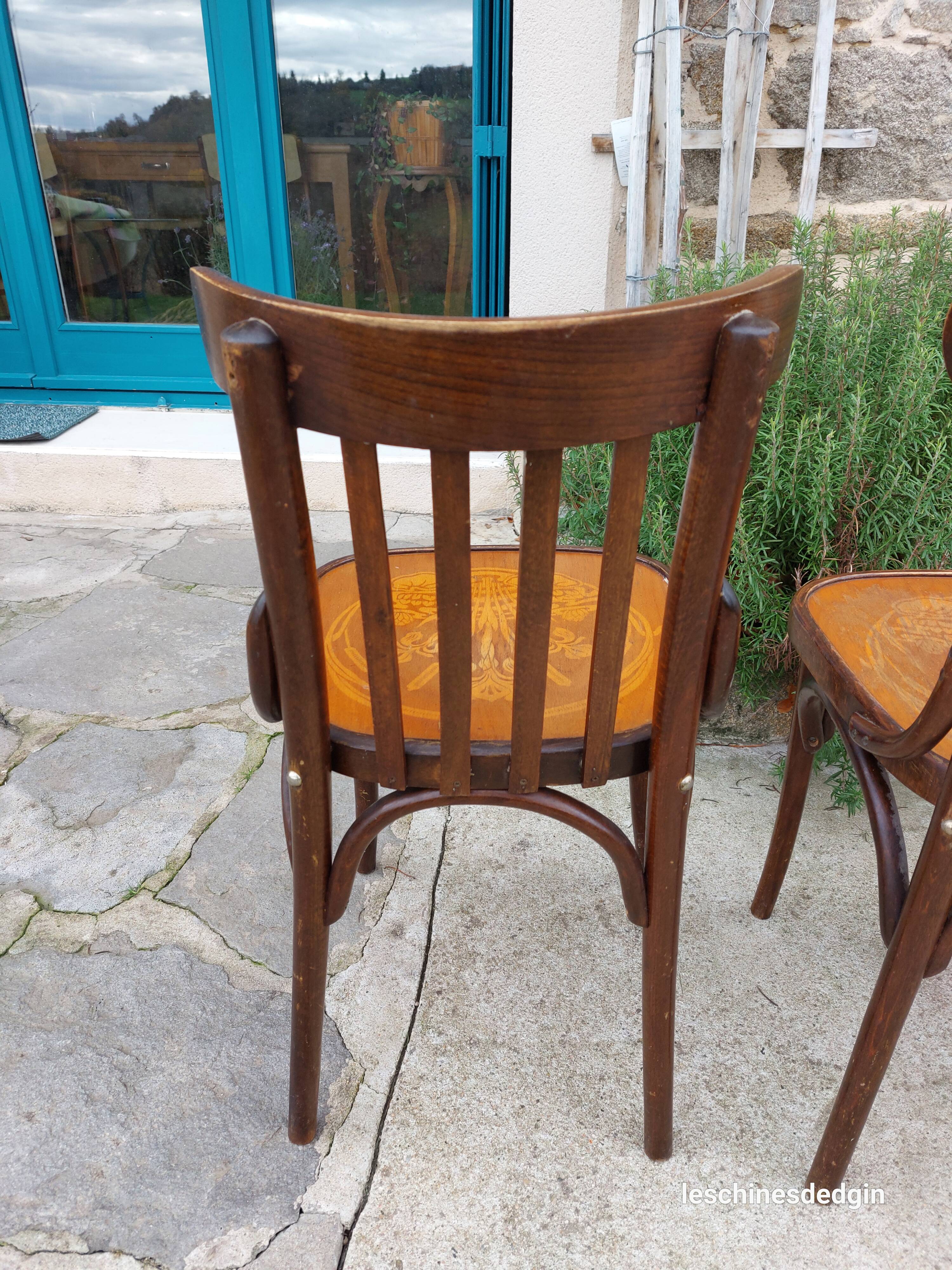 4 bentwood bistro chairs with a pattern on the seat
