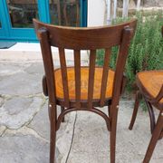 4 bentwood bistro chairs with a pattern on the seat