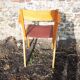 Old wooden and red leatherette bridge chair