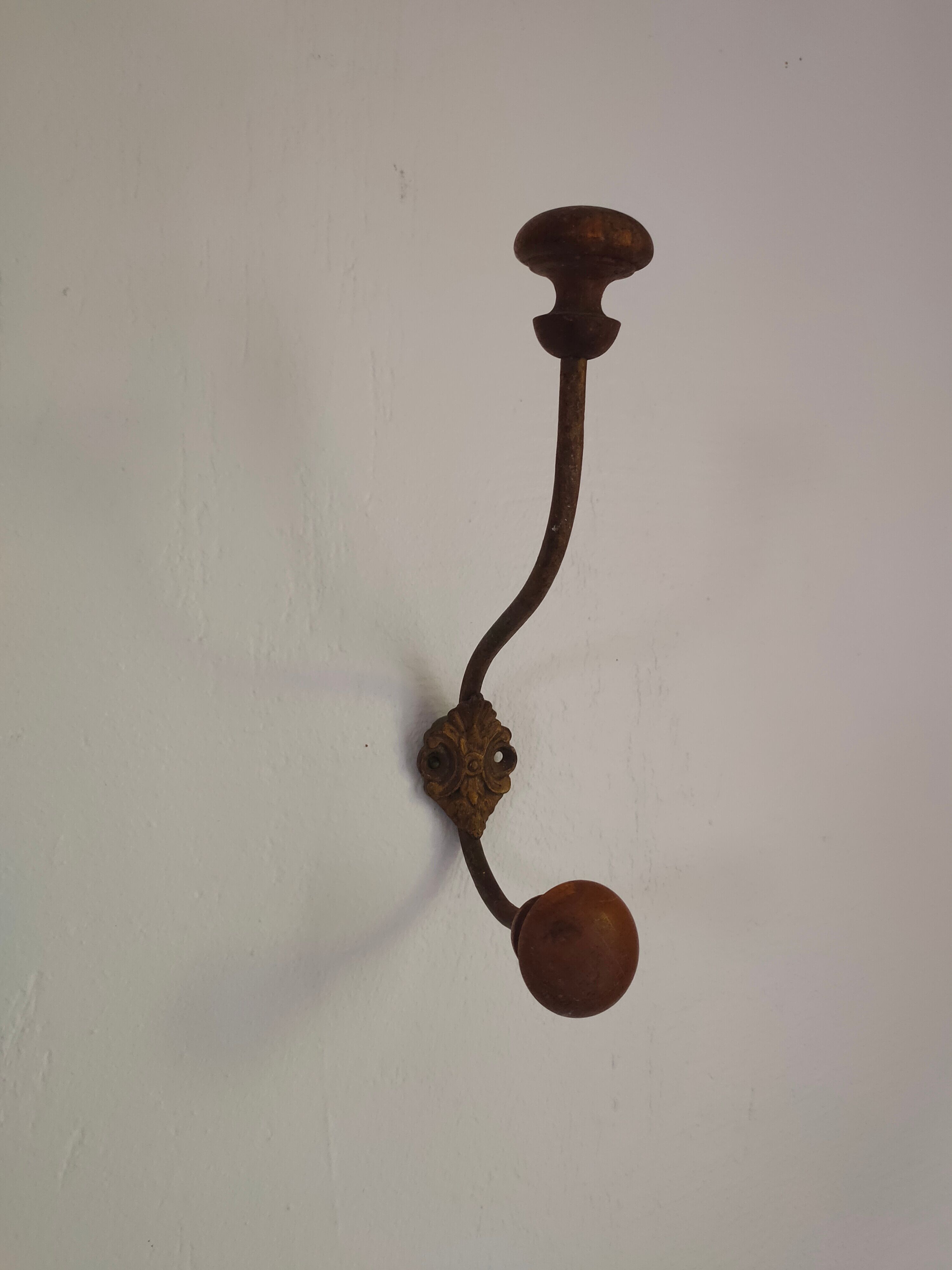 Wooden and metal wall coat rack.