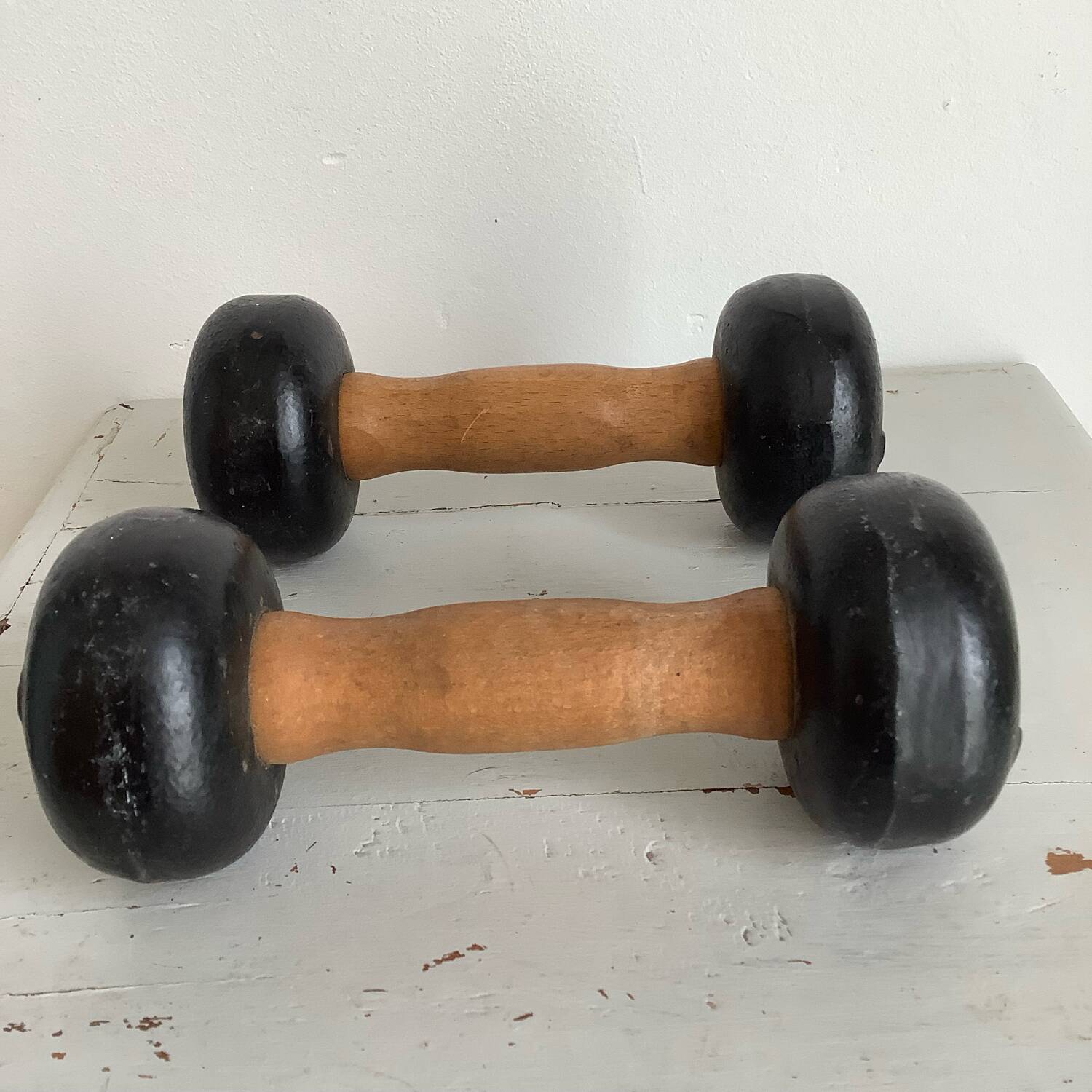 Pair of wooden and cast iron dumbbells