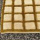 Very large Moroccan Berber rug in ecru and camel 400x300 cm with a grid pattern.