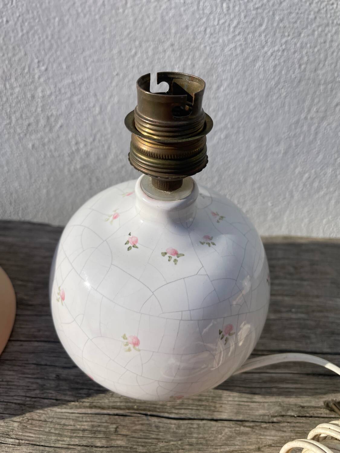 Small cracked white ceramic lamp with flowers.