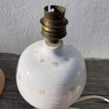 Small cracked white ceramic lamp with flowers.