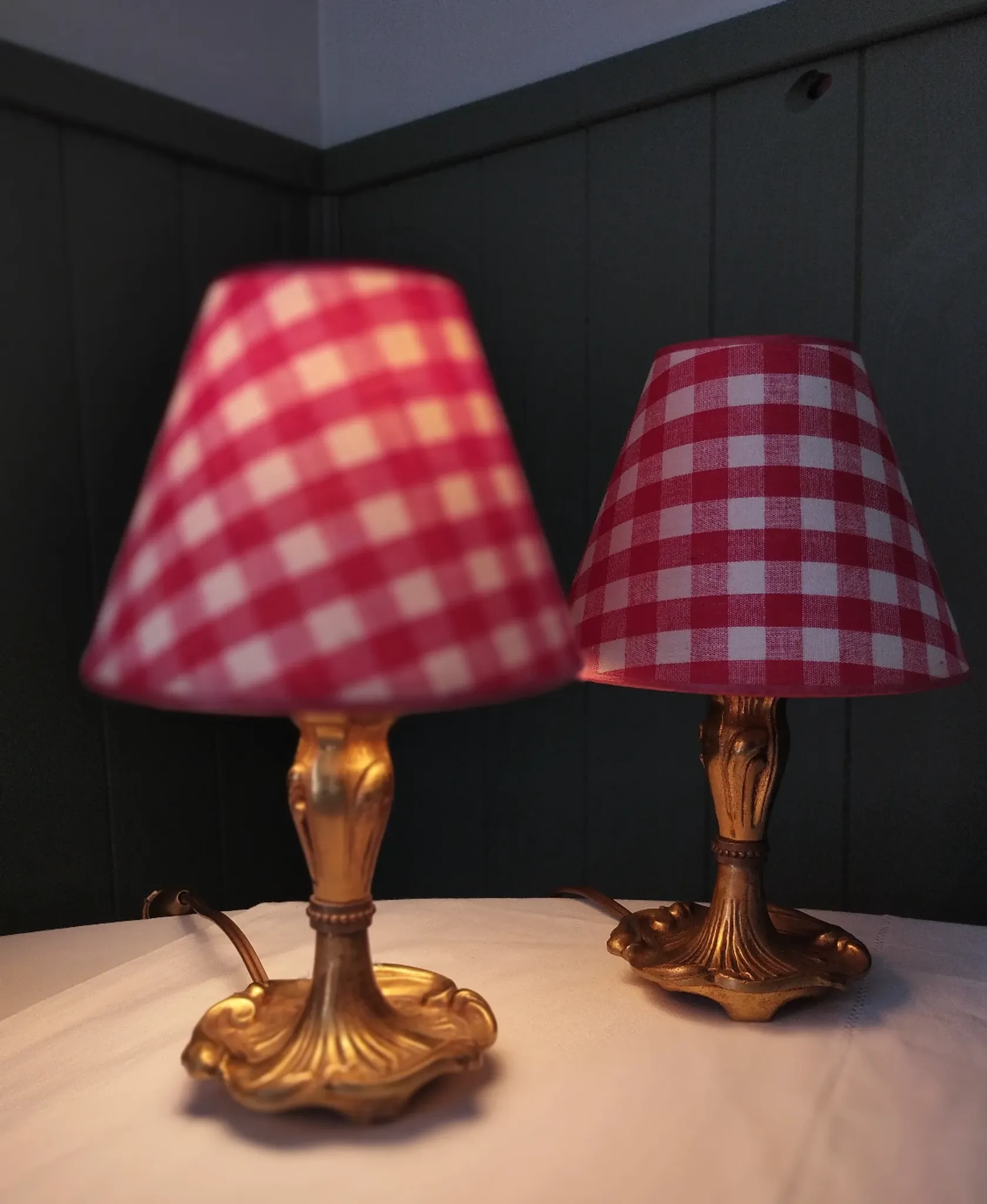 Pair of small lamps in gilded bronze by Petitot and red gingham lampshades.