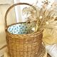 Wicker basket with waxed canvas blue flowers