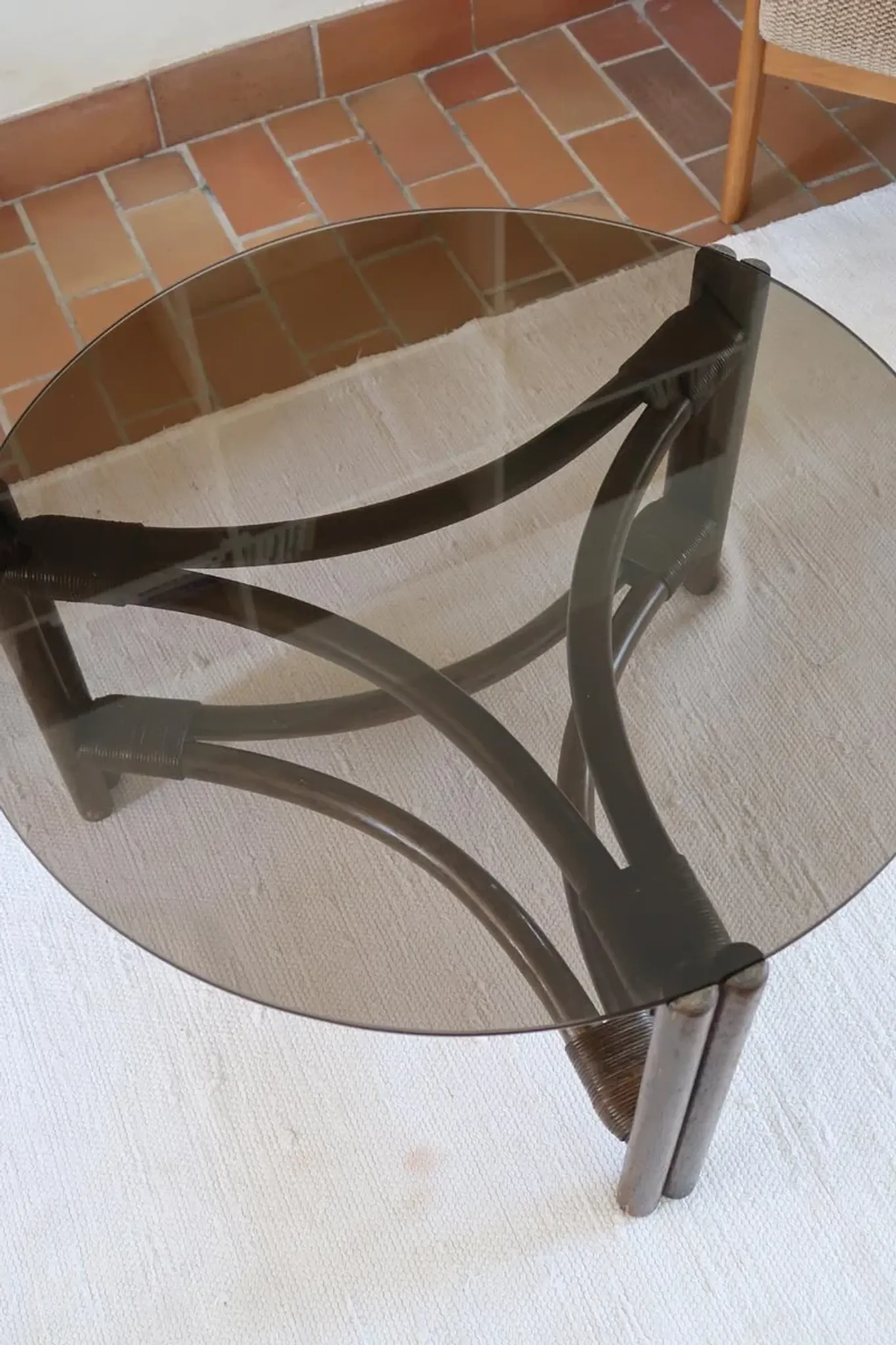 Round coffee table in rattan and smoked glass — 1970s