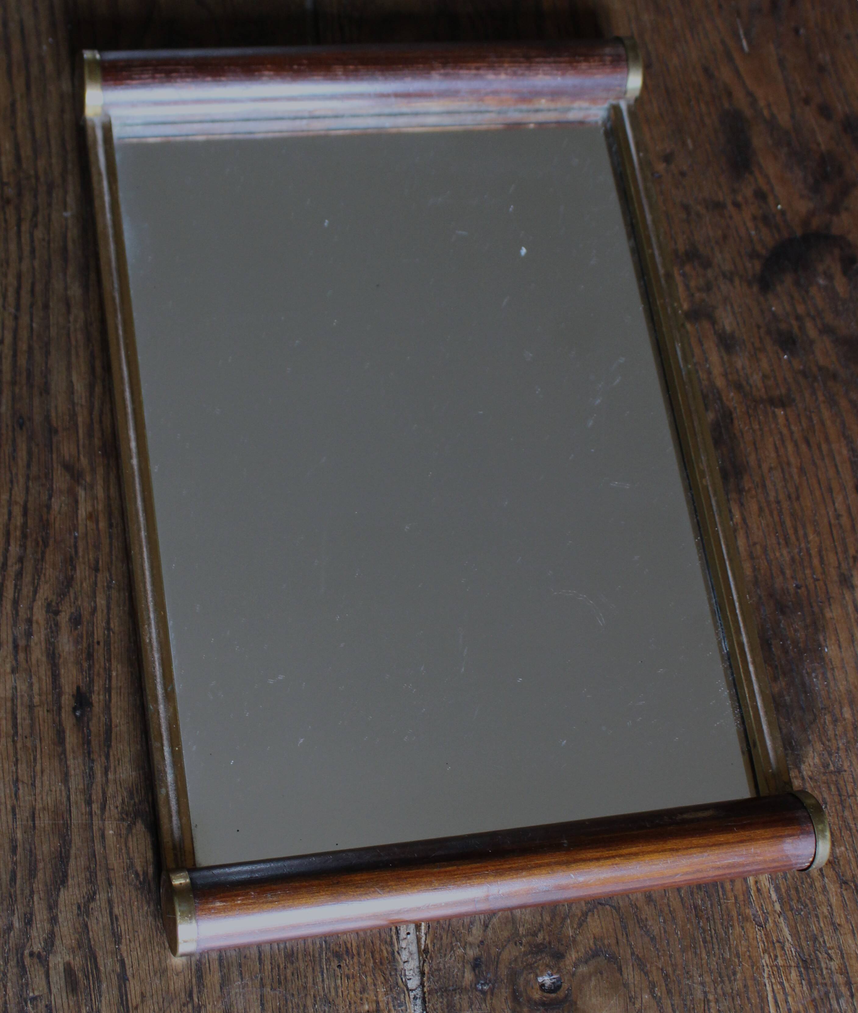 Rectangular mirror tray with wooden handles and gilding.