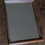 Rectangular mirror tray with wooden handles and gilding.