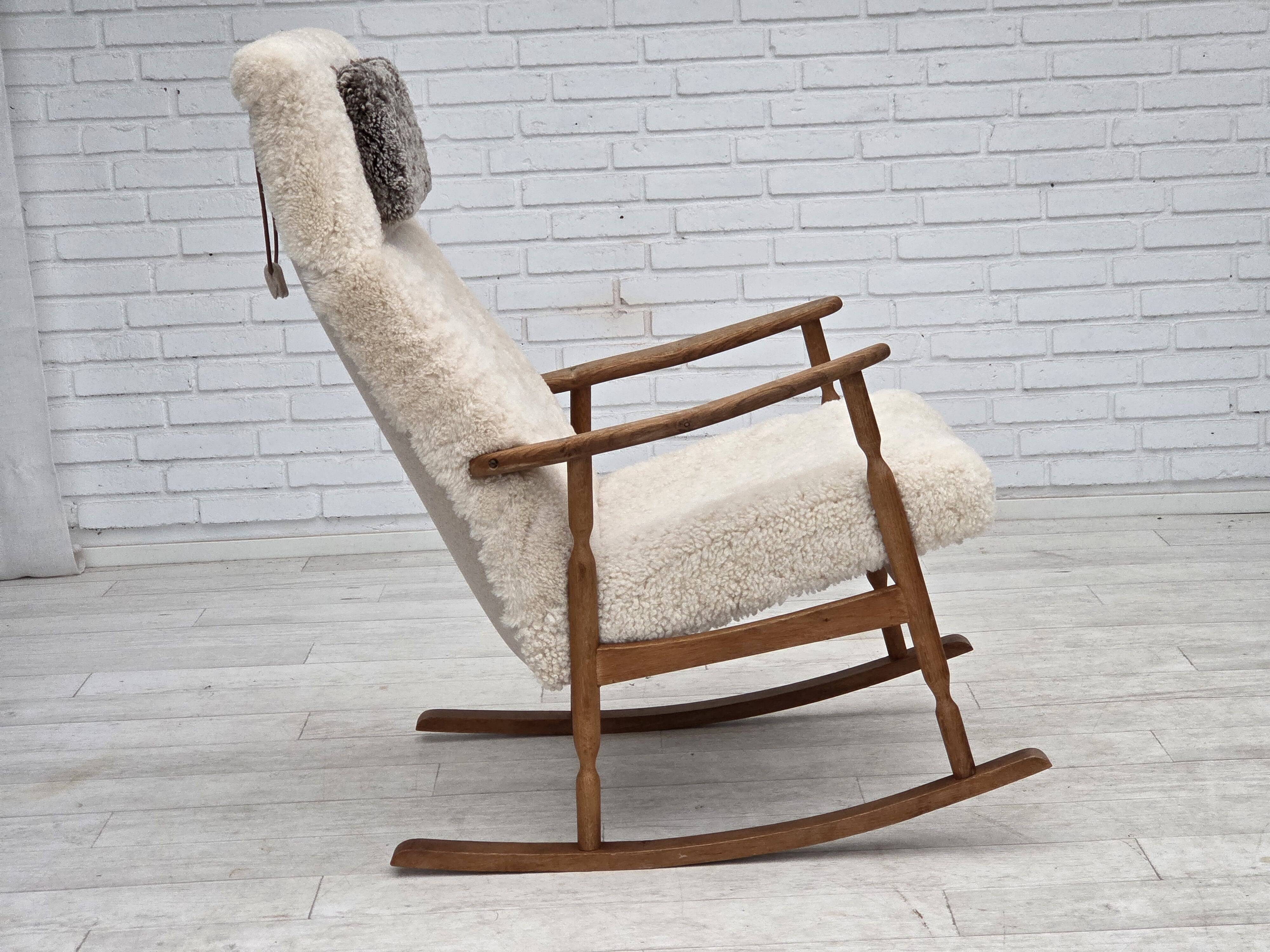 1970s, Danish rocking chair, reupholstered in quality genuine sheepskin.
