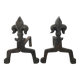 Pair of bronze fireplace firedogs with fleur-de-lys decor, art deco