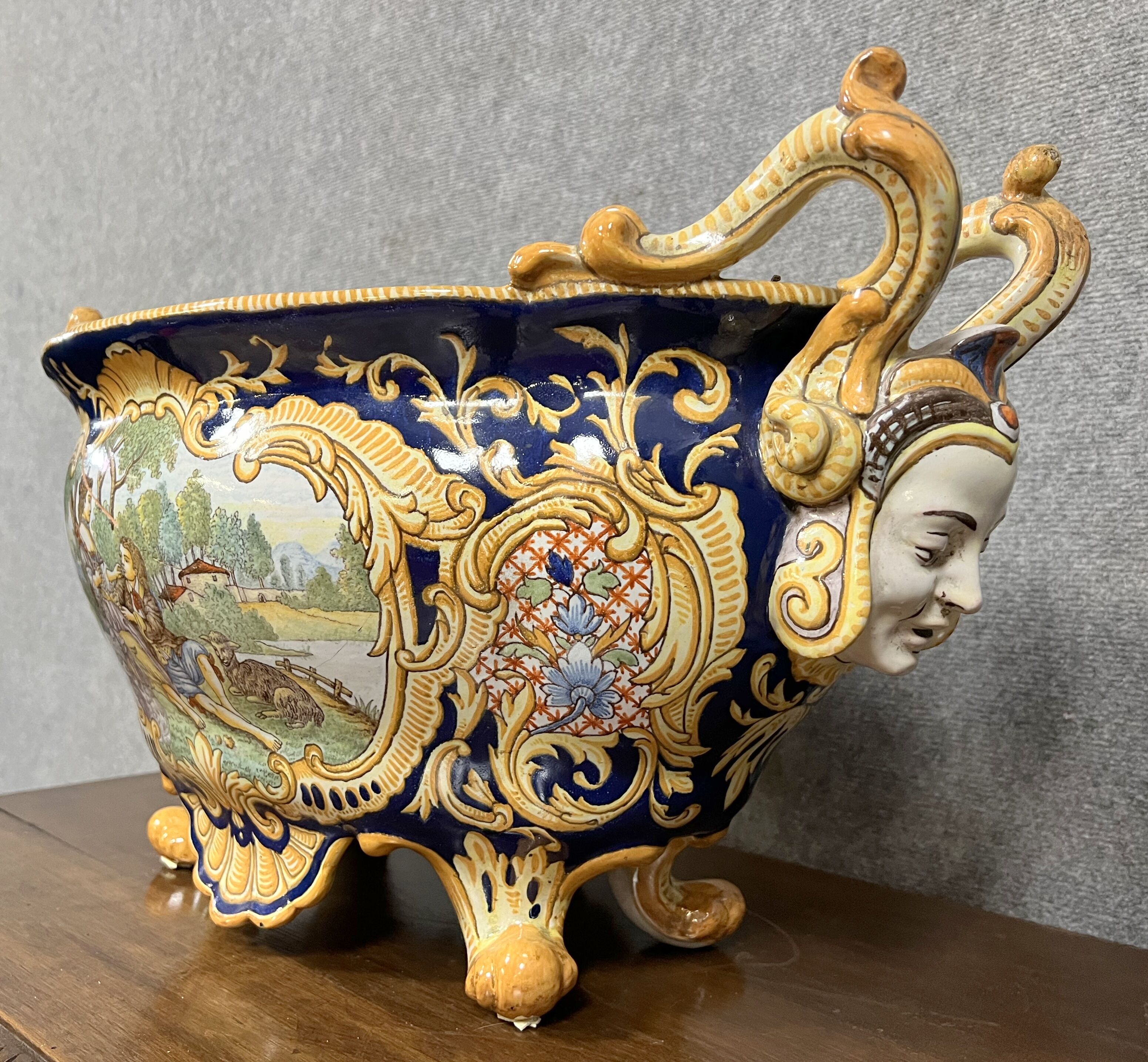 Earthenware planter with polychrome enamelled decoration on a blue background