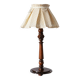 Table lamp with a carved wooden base and pleated lampshade