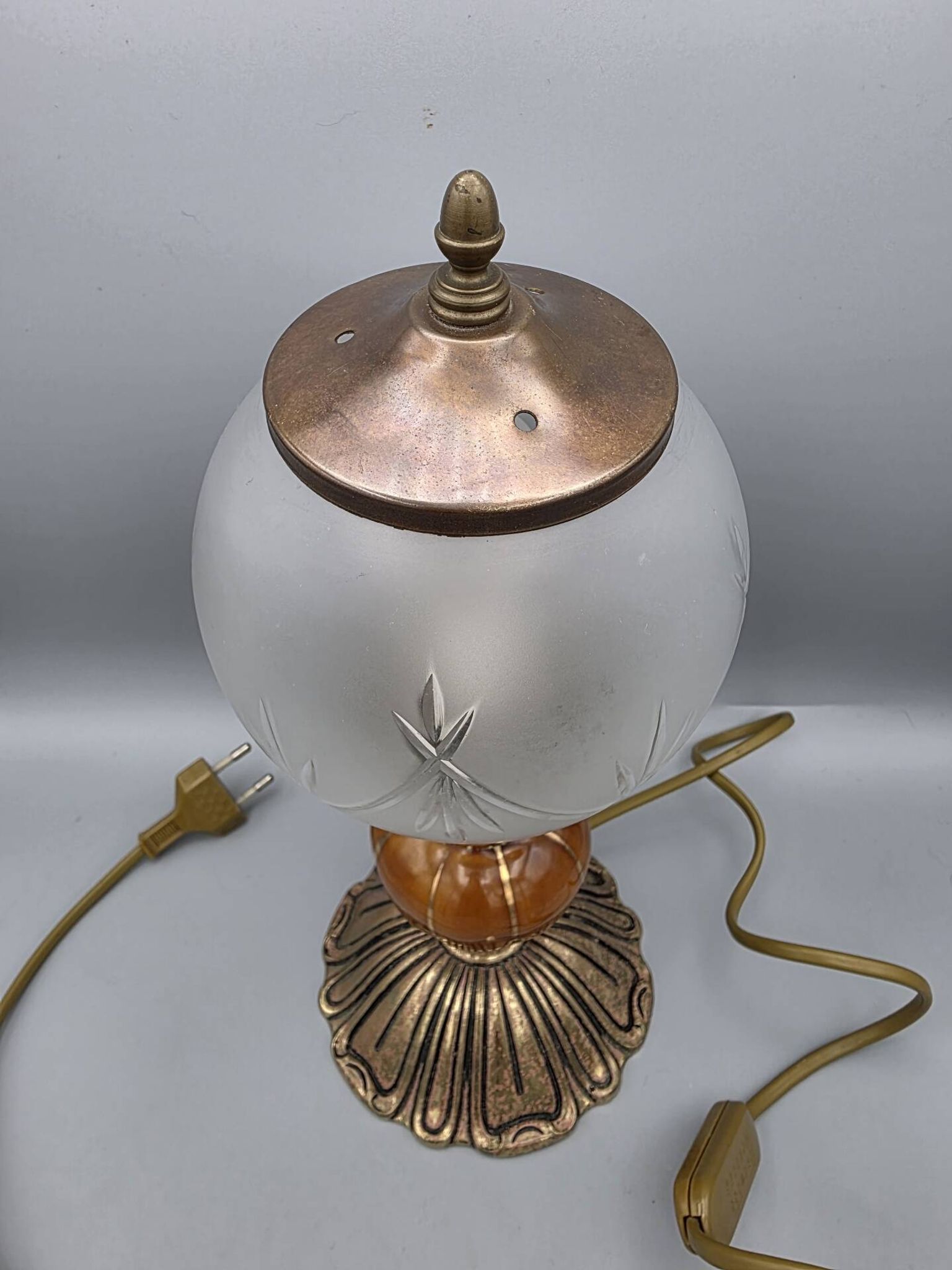 Hollywood Regency bedside lamp in gold metal with a glass globe.