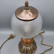 Hollywood Regency bedside lamp in gold metal with a glass globe.