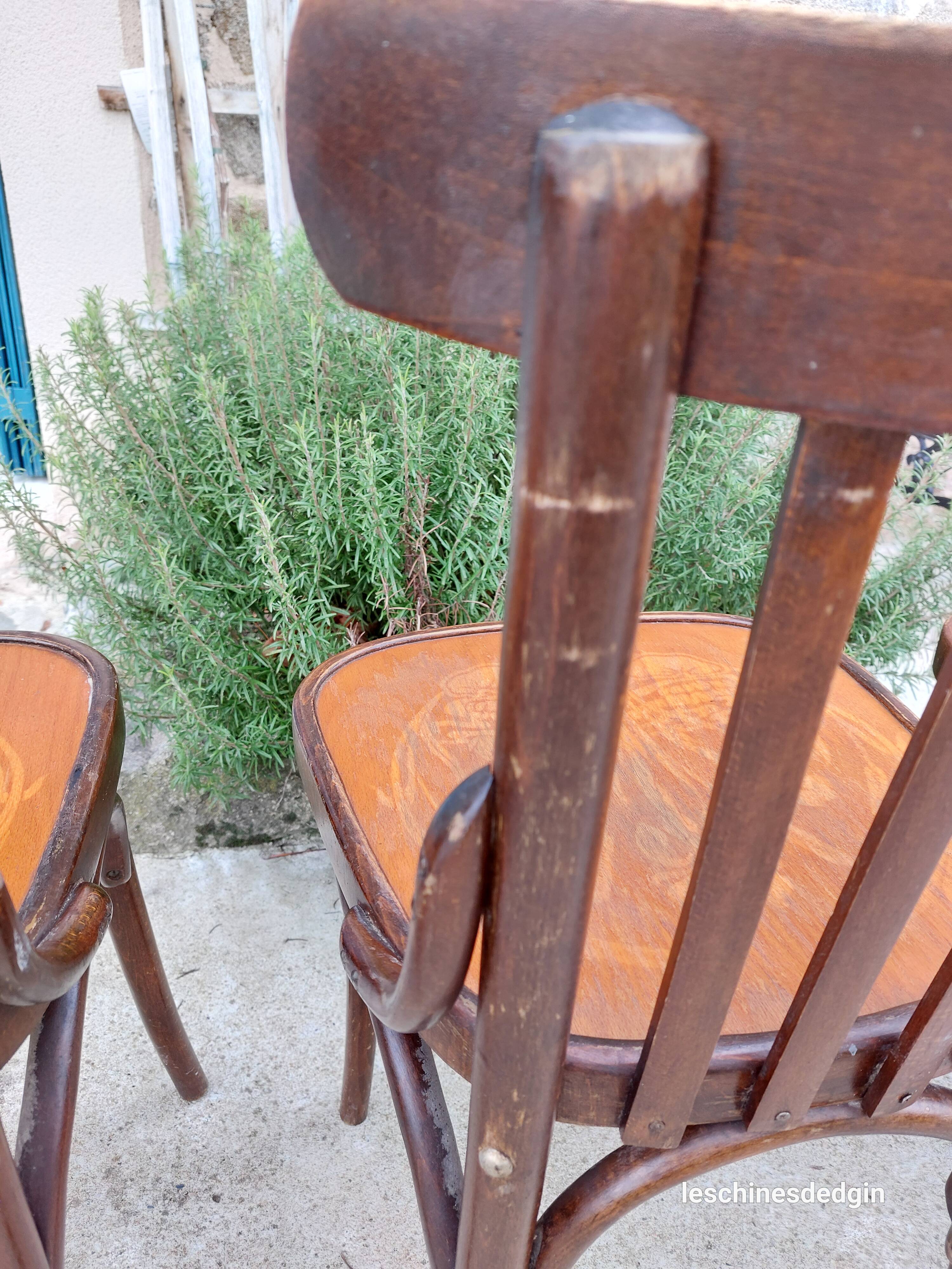 4 bentwood bistro chairs with a pattern on the seat