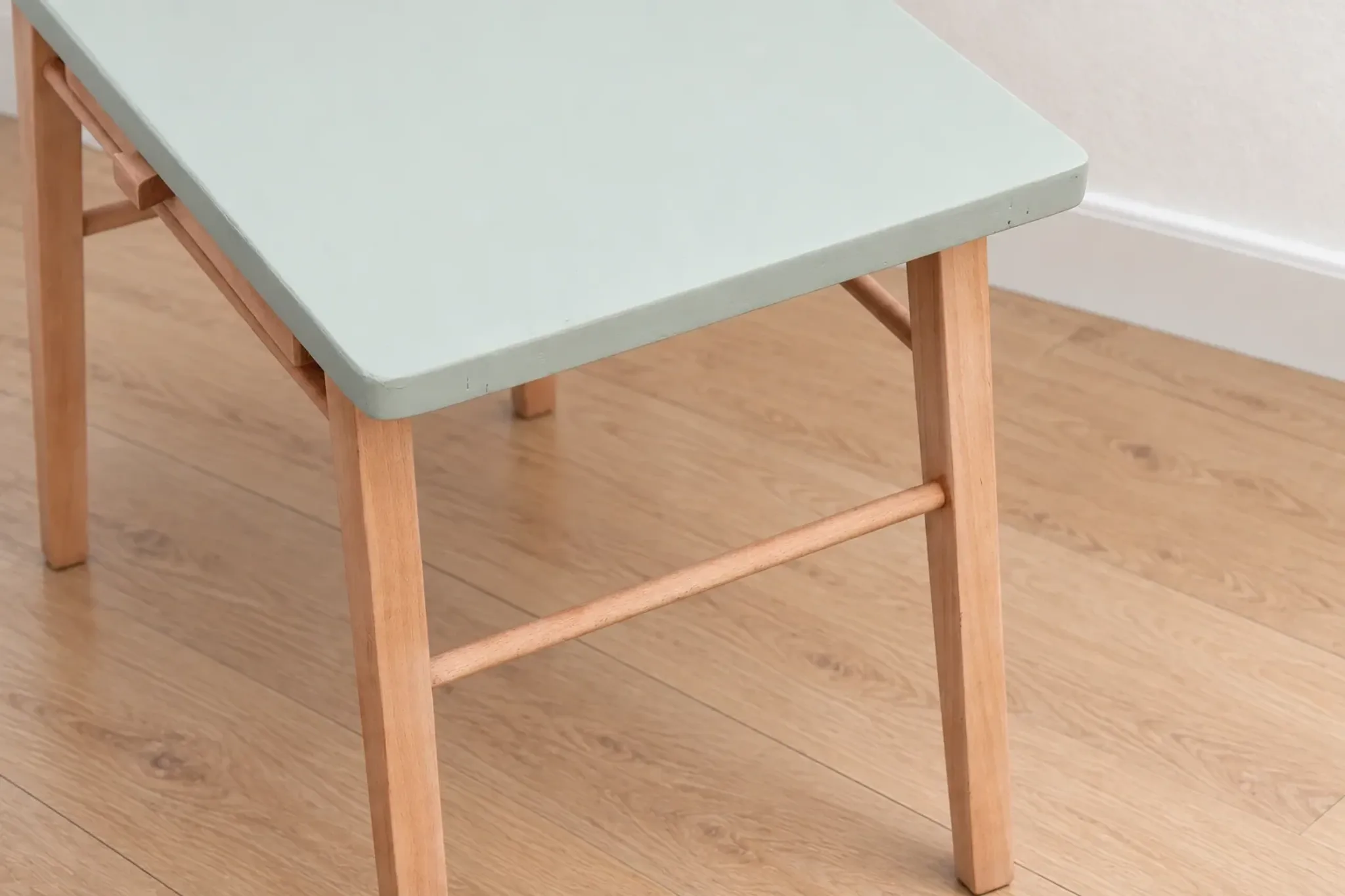 Small vintage children's desk attributed to Baumann – natural wood and lizard green top.
