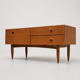 Teak sideboard with flap, 2 drawers and conical legs.