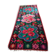 Colorful kilim on black background with floral design