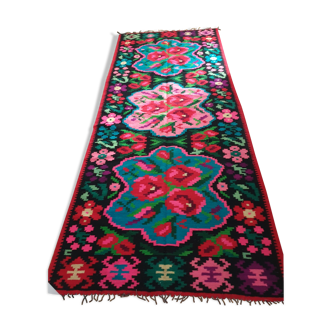 Colorful kilim on black background with floral design