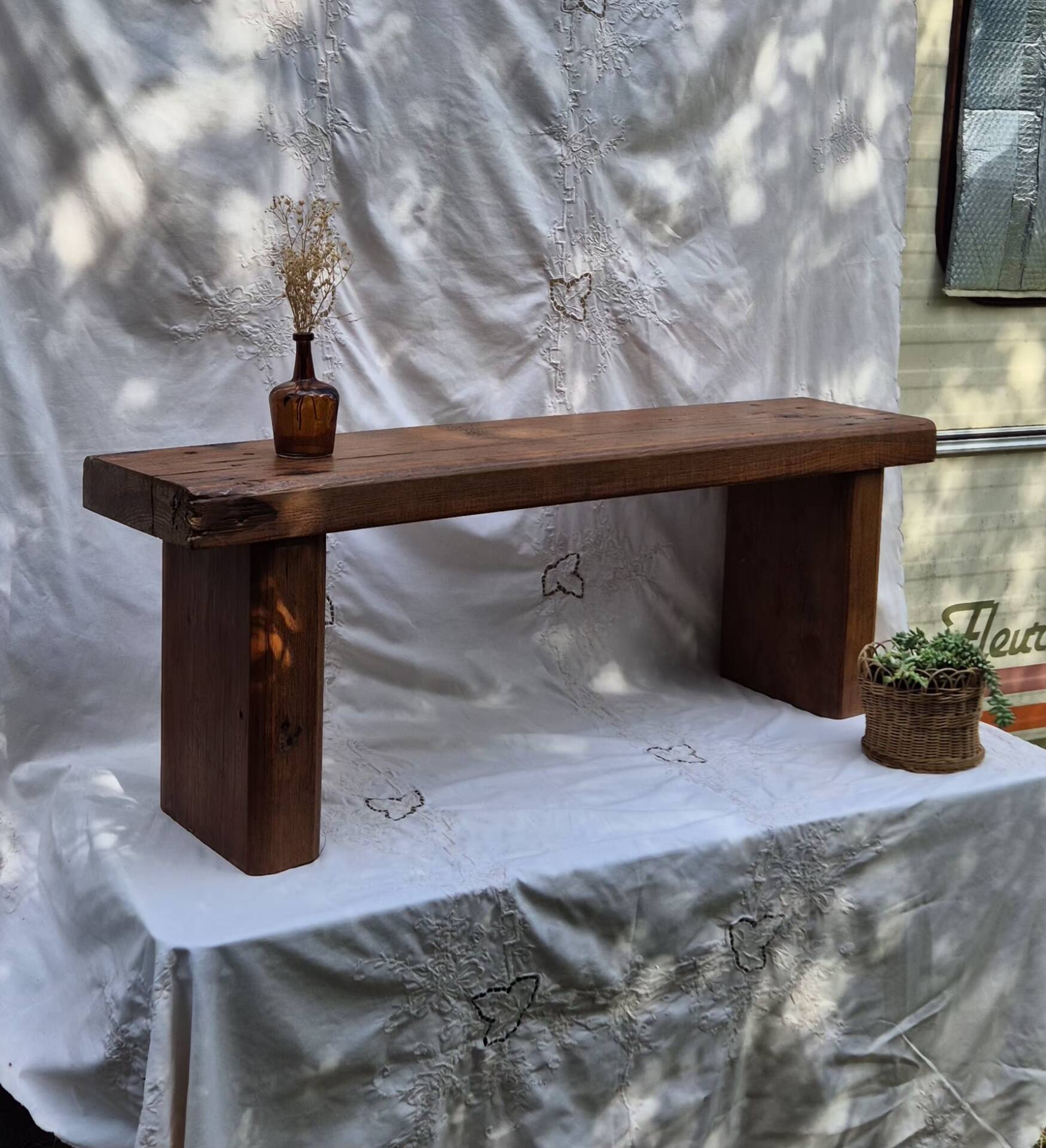 Brutalist wooden bench made of solid oak beam.
