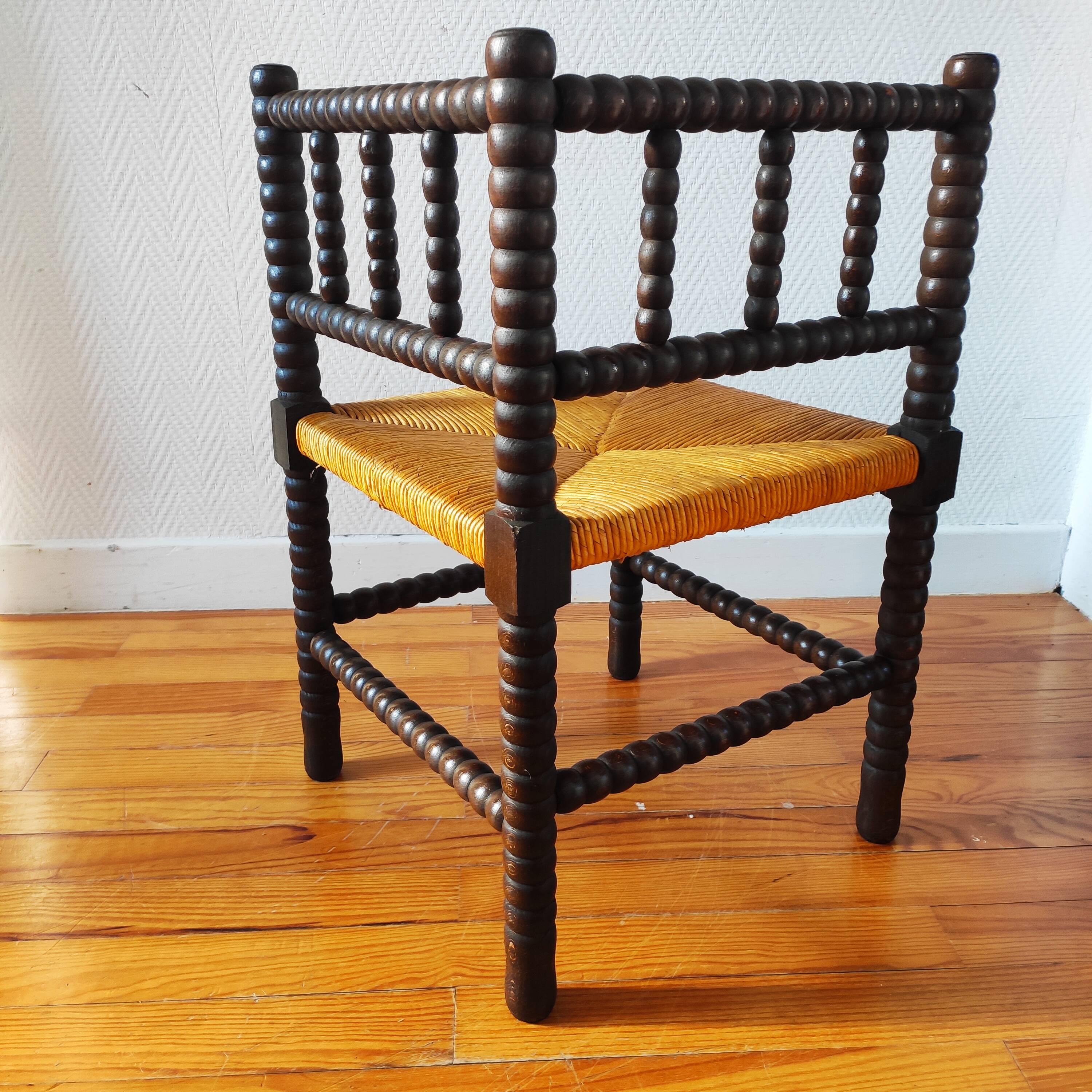 Antique corner chair made of turned wood.