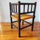 Antique corner chair made of turned wood.