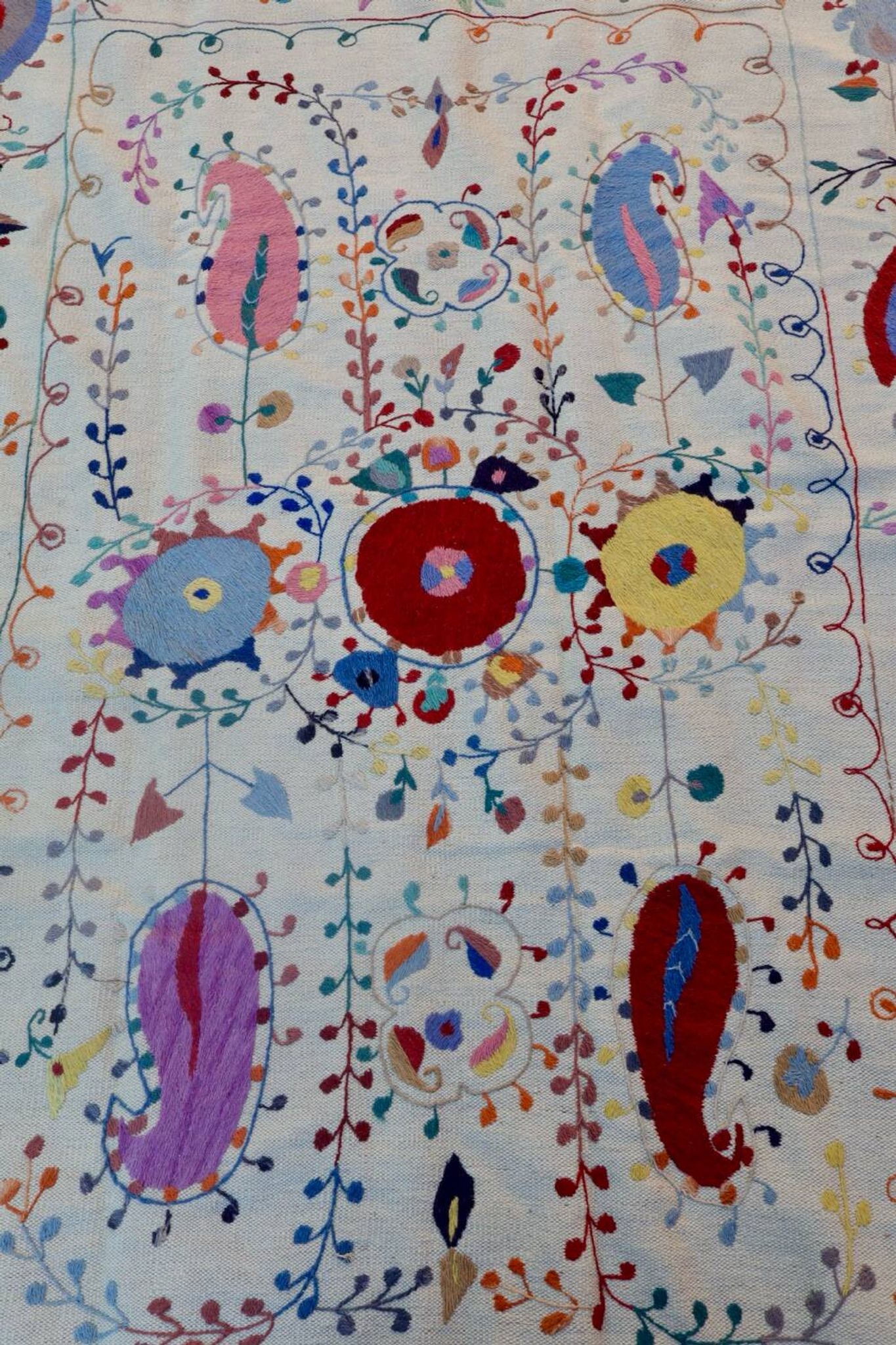 White suzani kilim rug with hand embroidered multi-colored patterns
