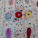 White suzani kilim rug with hand embroidered multi-colored patterns