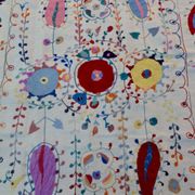 White suzani kilim rug with hand embroidered multi-colored patterns