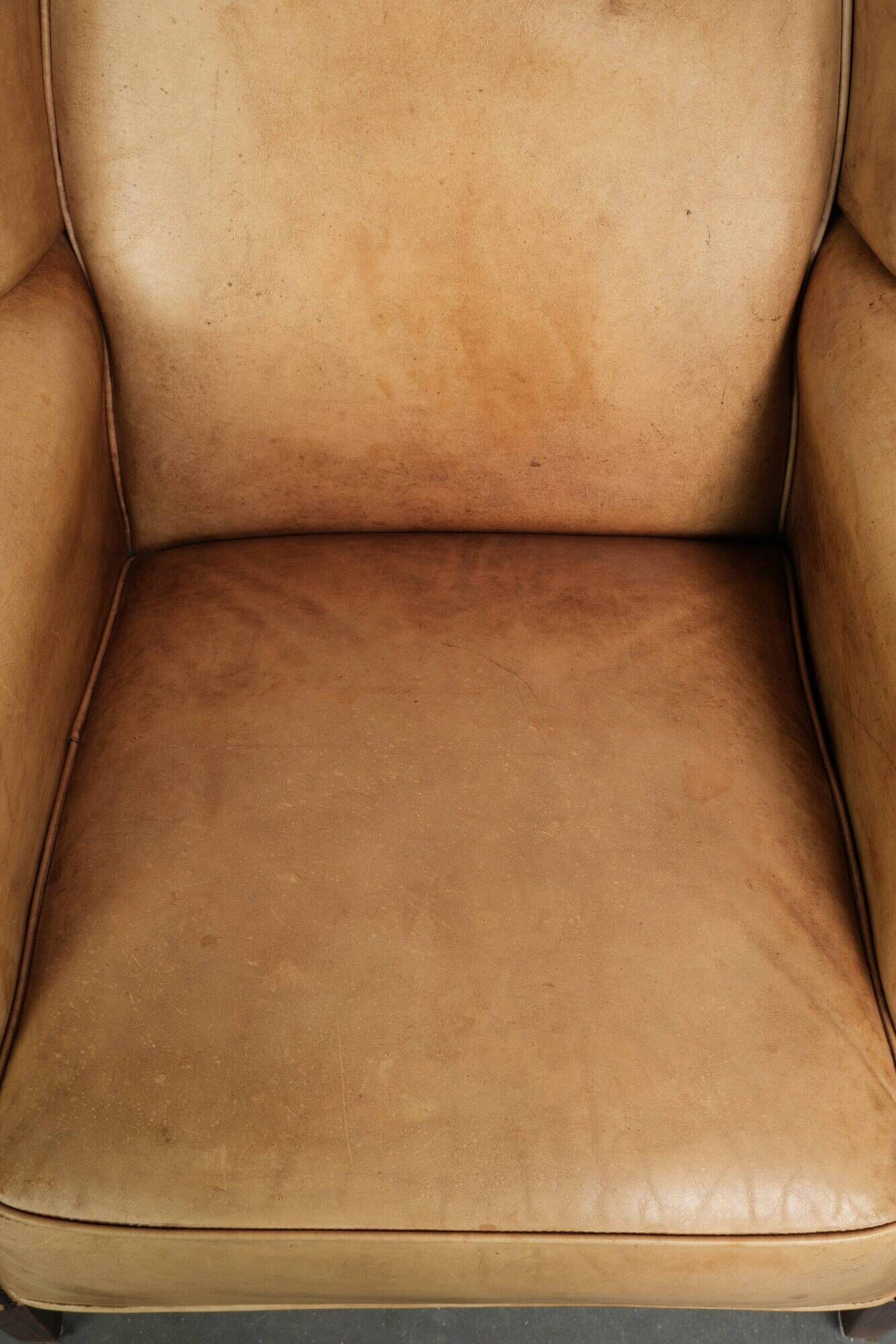 Set of two light cowhide wingback armchairs with a timeless English look
