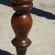 Walnut drop-leaf table with honey spoon legs.