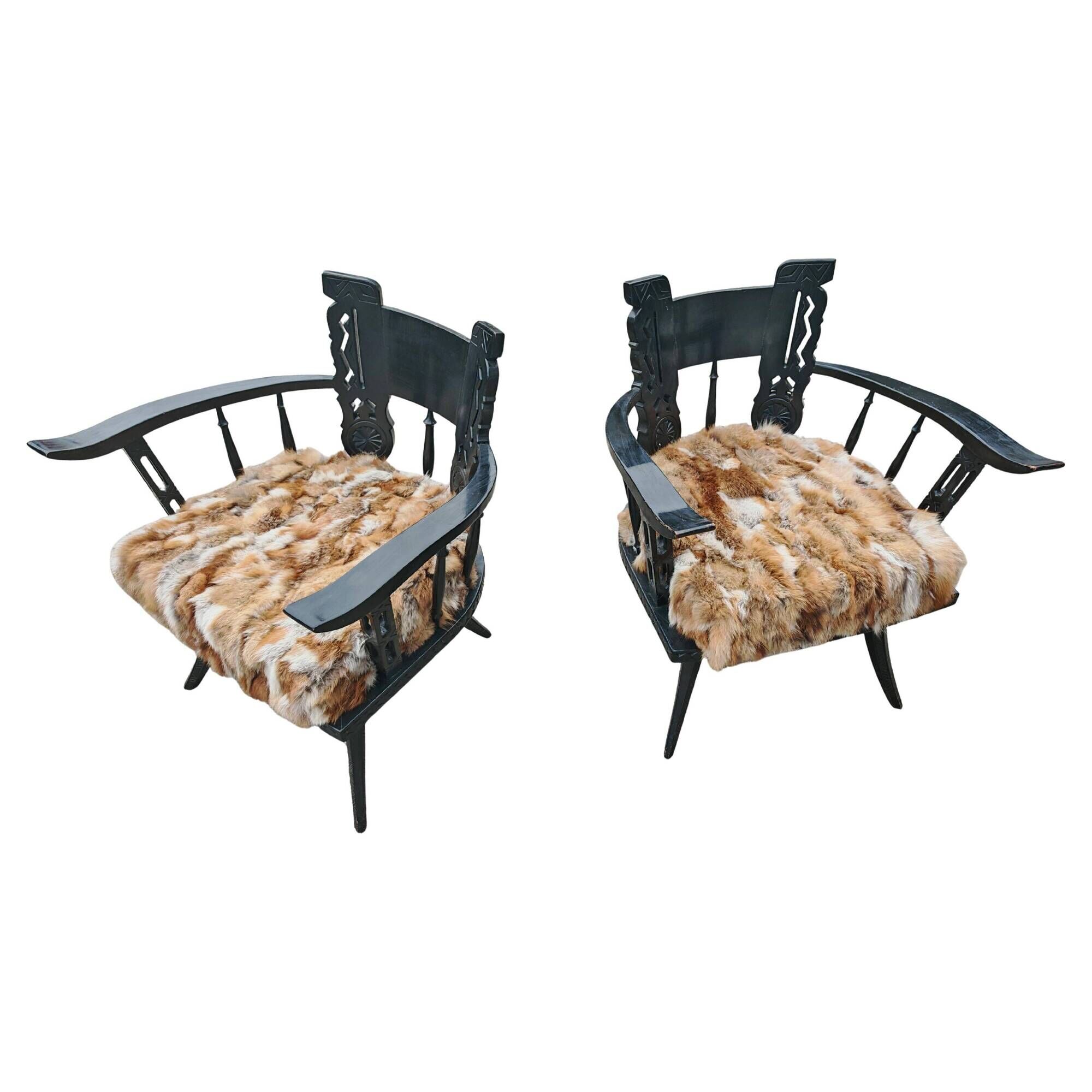 Pair of hand-carved armchairs in black lacquer and fur, 1920s.