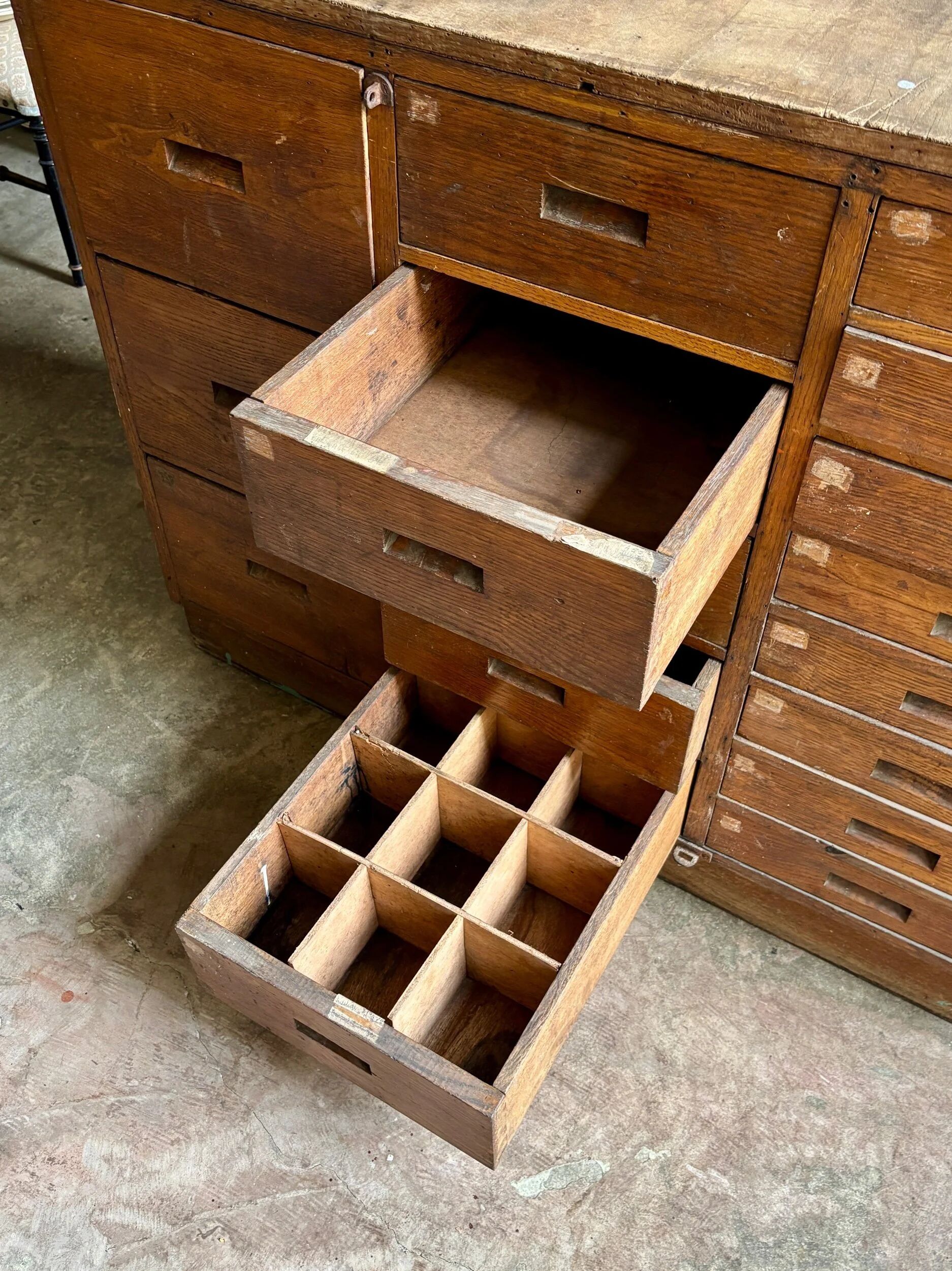 Craftsman's cabinet with 16 drawers in dark wood.