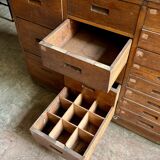 Craftsman's cabinet with 16 drawers in dark wood.