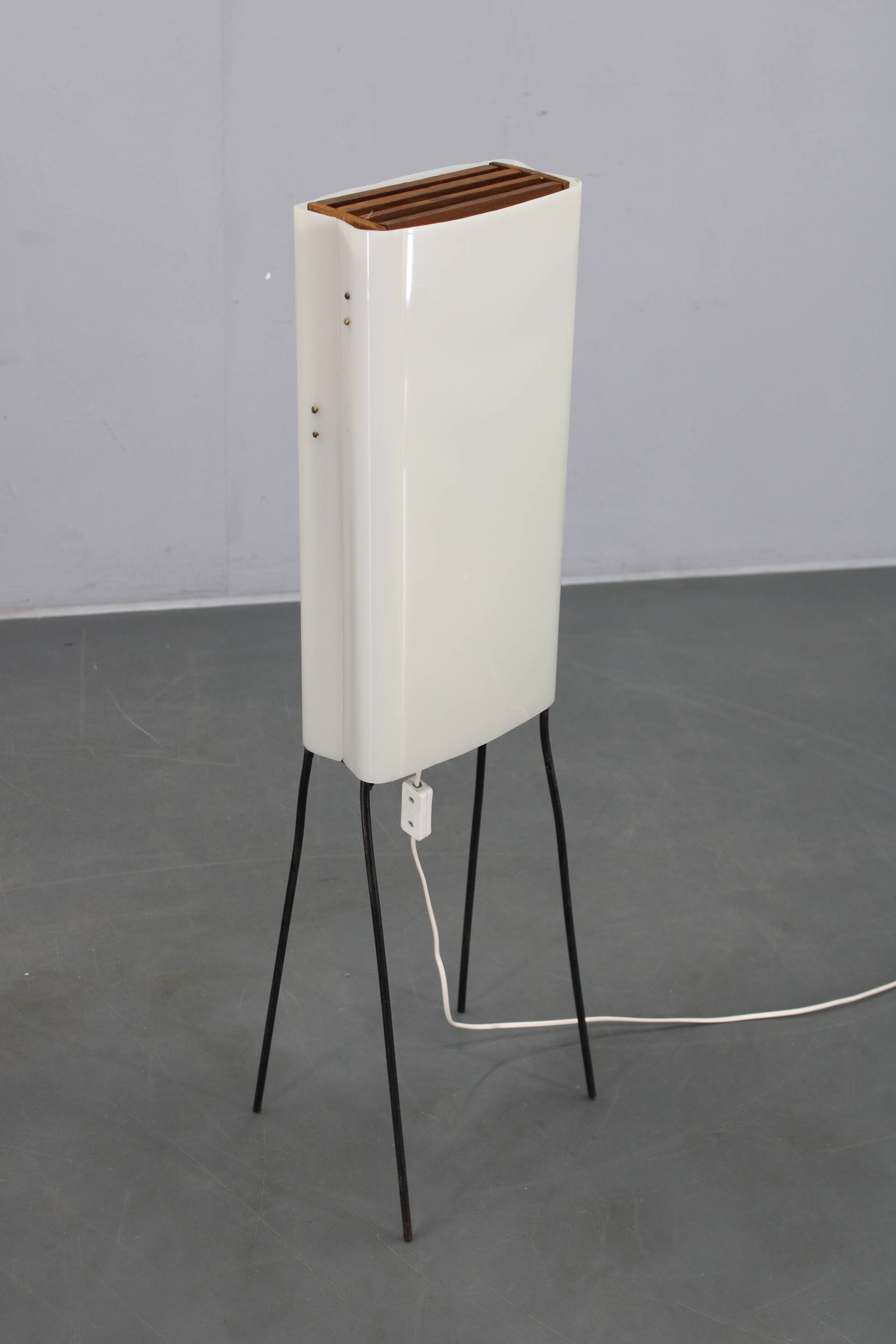 Mid-century modern floor lamp on iron legs with plastic shade and wood accent